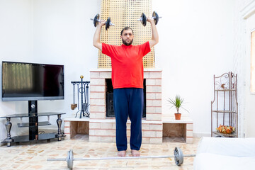 Athletic guy training hard at his home