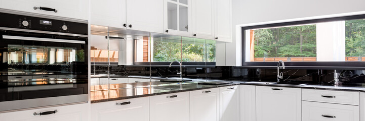 White kitchen with window, panorama