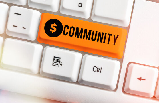 Text sign showing Community. Business photo showcasing group of showing with a common characteristics living together White pc keyboard with empty note paper above white key copy space