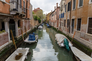 Venice, Italy - CIRCA 2020: View of an empty water canal in Venice Italy. Concept of the effects of lock down due to CoronaVirus COVID-19. Picturesque landscape.