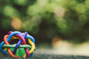 Colorful plastic baby toy on the grass