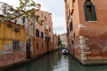 Fototapeta na wymiar Venice, Italy - CIRCA 2020: View of an empty water canal in Venice Italy. Concept of the effects of lock down due to CoronaVirus COVID-19. Picturesque landscape.