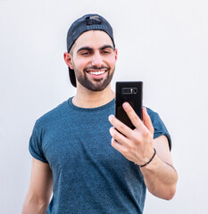 Guy taking selfie by his phone while smiling
