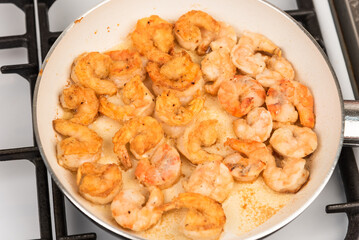 Shrimps fried in a pan - close-up, top view