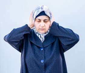 Arabic muslim woman shutting her ears from loud noise