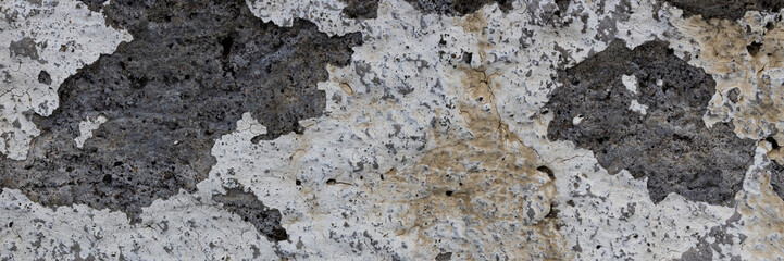 Old wall with cracked stucco. Weathered rough surface. Wide panoramic texture for background and design.
