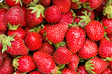 Closeup heap of ripe strawberrys. Organic food background.