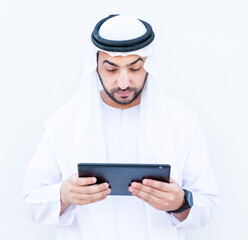 Arabic muslimman using tablet to study his lessons at school