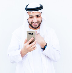 Arabic muslim guy using his smart phone to communicate with peop