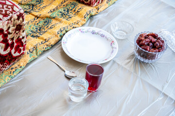 Arabic sit with date and water and juice preparing for iftar
