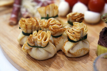 Close-up appetizer snacks. Filled russian blini in catering bar