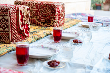 Arabic sit with date and water and juice preparing for iftar