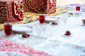Arabic sit with date and water and juice preparing for iftar