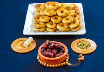 Eid sweets in a white bowl wiht some date