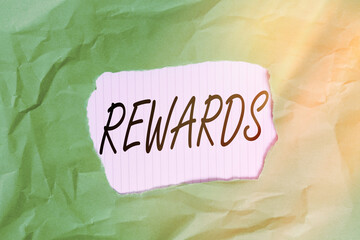 Writing note showing Rewards. Business concept for certain number or percentage you earn for every...