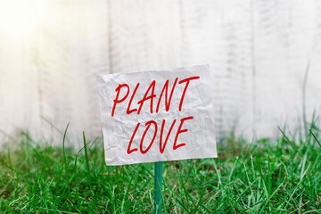 Conceptual hand writing showing Plant Love. Concept meaning a symbol of emotional love, care and...