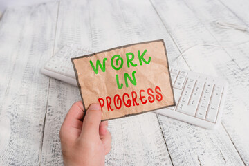 Conceptual hand writing showing Work In Progress. Concept meaning Ongoing Business with teamwork,...