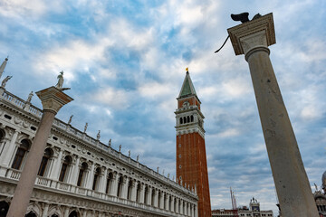Fototapeta na wymiar St Mark's Campanile is the bell tower of St Mark's Basilica made of red bricks and white marble in Venice,