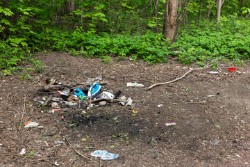 A pile of garbage in the forest.