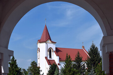 View through arch on Roman Catholic Church of St. Joseph.  Church is built in  Gothic style. Walls...