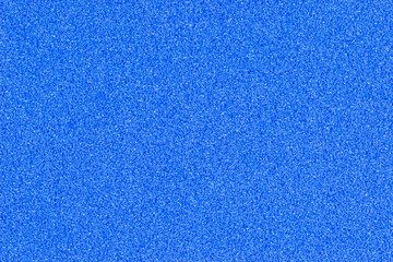 A macro photo of a blue gradient color with texture from real foam sponge paper for background, backdrop or design.