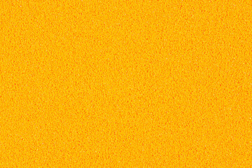 A macro photo of a orange gradient color with texture from real foam sponge paper for background, backdrop or design.