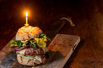 home made cheeseburger on dark wood