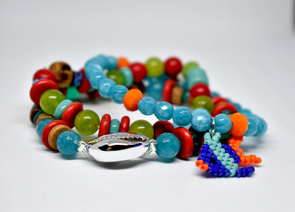 A group of colorfull bracelets on a white background