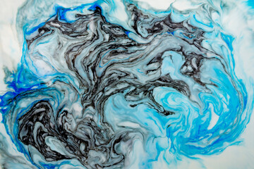 The background is painted blue in the Ebru style