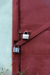 Two gray locks on a burgundy door. Perfect protection.