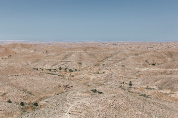 Desert mountain landscape with rare palm trees. Tunisia berber dwelling
