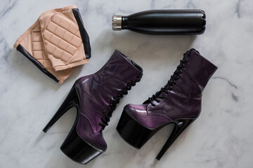 Pole fitness flat lay. High heels, knee pads, water bottle. 