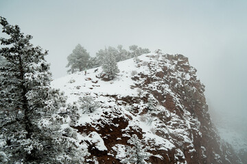 walking up a mountain in snow