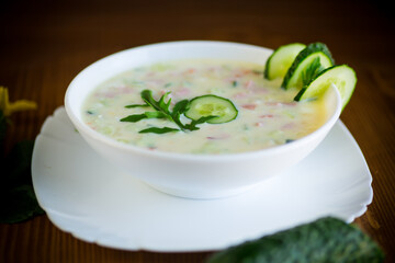 summer cucumber soup with vegetables on a wooden table
