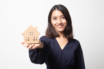 Happy young asian woman with house model.