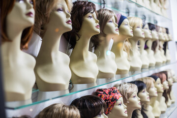 Rows of hair wigs - obrazy, fototapety, plakaty