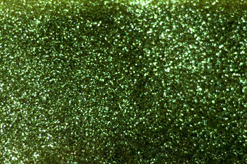 Shimmering emerald background with sparkles. Festive or summer decor. Blurred effect. Summer time or hello summer.