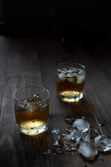 Glass of whiskey with ice and spray. Beautiful food photo.