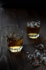 Glass of whiskey with ice and spray. Beautiful food photo.