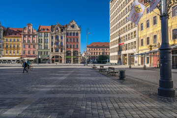Fototapeta na wymiar Market Square, Wroclaw, Poland - April 21, 2019: Central square in Wroclaw Old Town since the Middle Ages, surrounded by ornamented and colorful frontages of historical tenement houses.