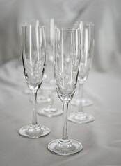 Empty wineglasses on background of white fabric