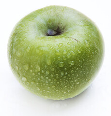 Wet green apple isolated on white