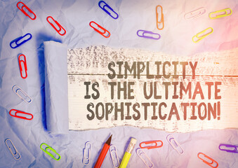 Handwriting text writing Simplicity Is The Ultimate Sophistication. Conceptual photo simplify presentations best result Rolled ripped torn cardboard placed above a wooden classic table backdrop
