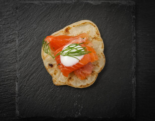 Salted salmon with dill on a pancake.