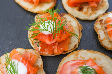 Salted salmon with dill on a pancake.