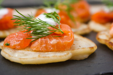 Salted salmon with dill on a pancake.