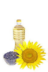 Bottle of sunflower oil with flower and seed isolated on white background