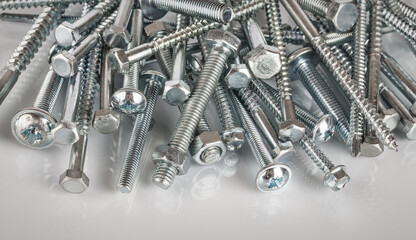 Assortment of bolts, screws and metal nails, selective focus