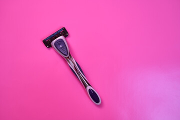 Shaving machine on a pink background. With copy space.