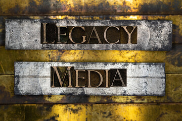Legacy Media text formed with real authentic typeset letters on vintage textured silver grunge copper and gold background
